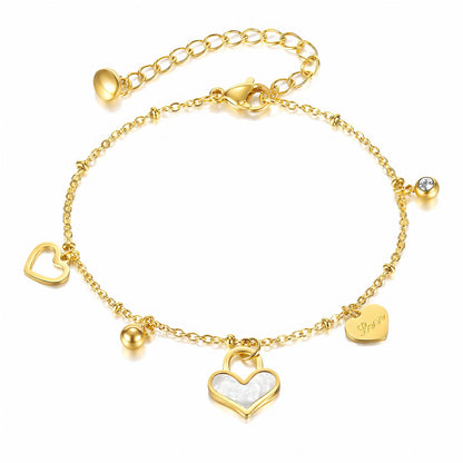 Heart Charm Bracelet in gold with white and gold heart charms on a fine chain