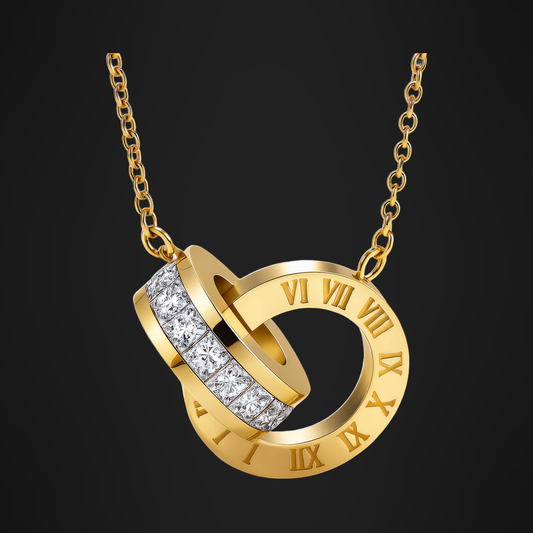 Interlocking Rings Necklace in PVD gold over 316L stainless steel, a Roman numeral ring linked through a pave band, on a black ground