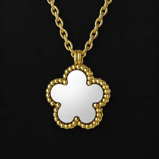 Flower Pendant Necklace in PVD gold over 316L stainless steel, small flower pendant on a fine chain, on a black ground