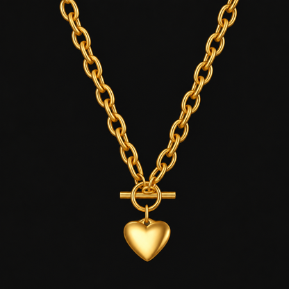 Heart Toggle Necklace in PVD gold over 316L stainless steel, weighted chain with a toggle clasp and small heart, on a black ground